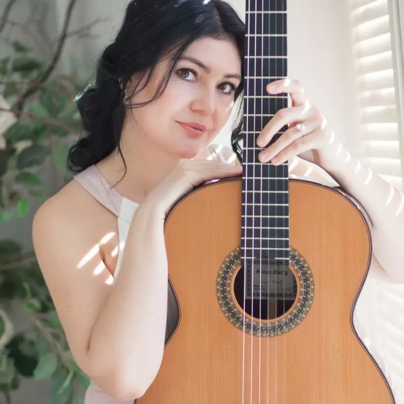 Irina Kulikova con la chitarra accanto al viso
